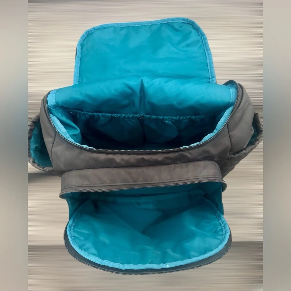 Skip Hop Forma Diaper Backpack. Black Exterior with Teal Interior.